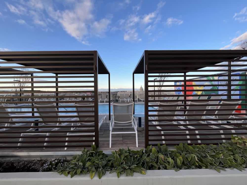 Rooftop terrace with timber pergolas framing the Capitol dome
